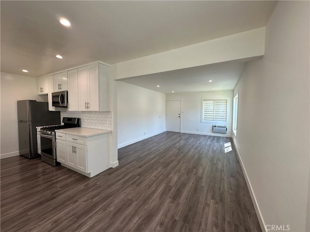1942 S Sherbourne Dr, Los Angeles, CA 90034 - kitchen with appliances with stainless steel finishes, dark wood-type flooring, white cabinets, light countertops, and decorative backsplash