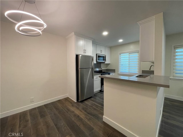 1942 S Sherbourne Dr, Los Angeles, CA 90034 - kitchen featuring appliances with stainless steel finishes, white cabinets, dark wood-style flooring, recessed lighting, and a chandelier