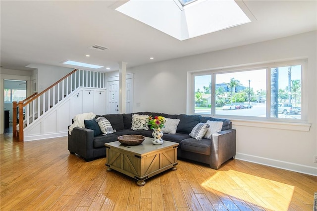 8042 Driftwood Dr, Huntington Beach, CA 92646 - living area with a skylight, light wood finished floors, stairway, and recessed lighting