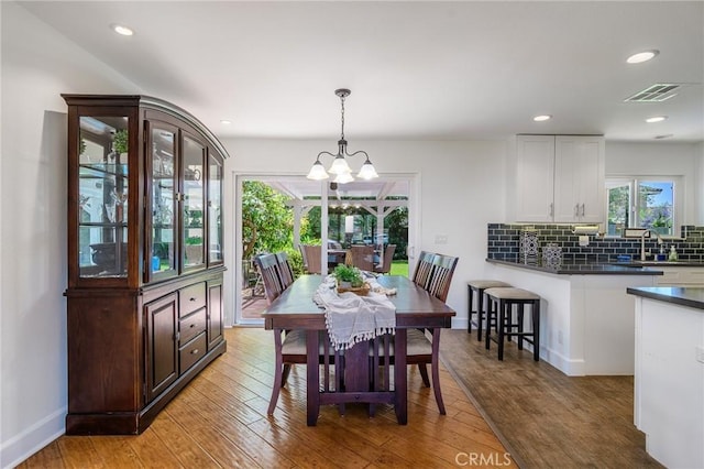 8042 Driftwood Dr, Huntington Beach, CA 92646 - dining area with light wood-style floors, a chandelier, and recessed lighting