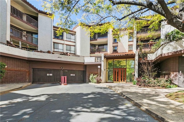 4210 Via Arbolada Unit 317, Los Angeles, CA 90042 - view of property featuring an attached garage and driveway