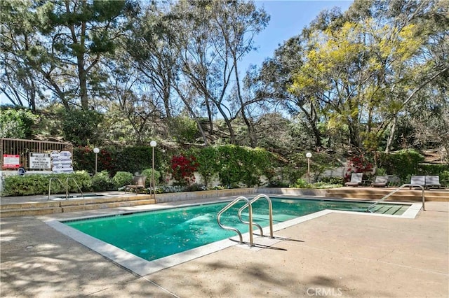4210 Via Arbolada Unit 317, Los Angeles, CA 90042 - view of swimming pool with a patio area and view of wooded area