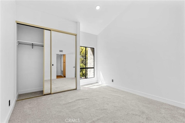4210 Via Arbolada Unit 317, Los Angeles, CA 90042 - unfurnished bedroom featuring carpet floors, high vaulted ceiling, and a closet