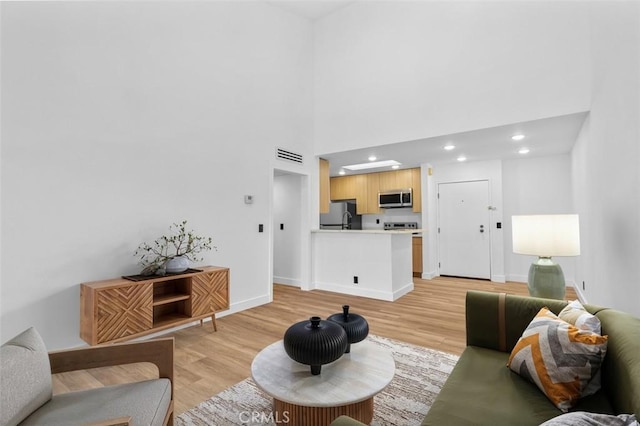 4210 Via Arbolada Unit 317, Los Angeles, CA 90042 - living area with light wood-style flooring, recessed lighting, and a high ceiling