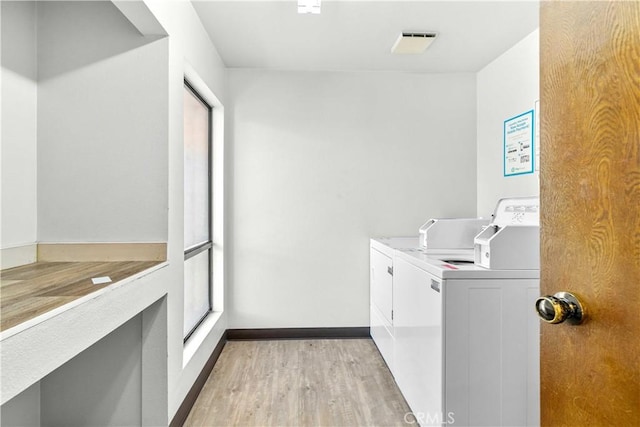 4210 Via Arbolada Unit 317, Los Angeles, CA 90042 - shared laundry room with separate washer and dryer and light wood-style floors