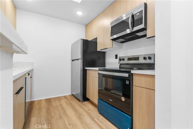 4210 Via Arbolada Unit 317, Los Angeles, CA 90042 - kitchen featuring appliances with stainless steel finishes, light brown cabinets, light wood-type flooring, light countertops, and recessed lighting