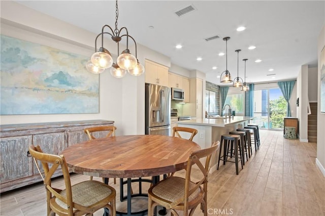 1019 Sequoia Pl, Montebello, CA 90640 - dining room with light wood-style floors and recessed lighting