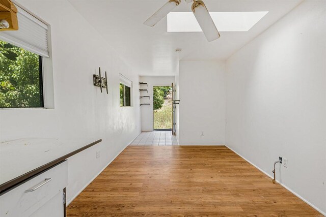 29556 Sierra Rojo Ln, Valley Center, CA 92082 - empty room with a skylight, light wood-style floors, and a ceiling fan