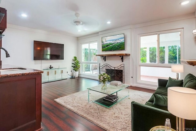 12919 Evalyn Pl, Poway, CA 92064 - living area with dark wood finished floors, a brick fireplace, and recessed lighting