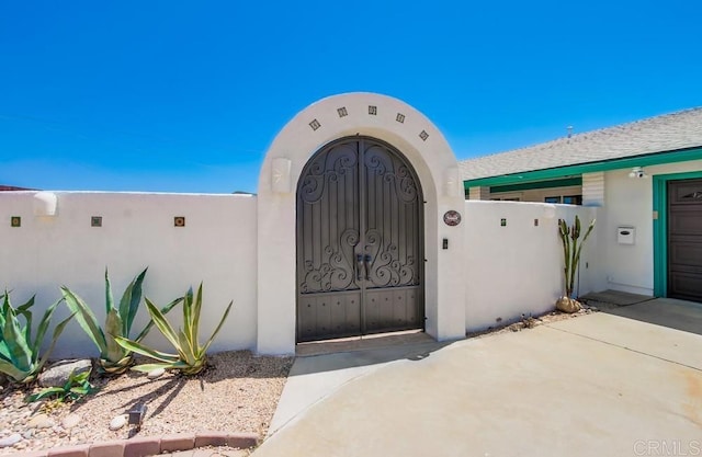 12919 Evalyn Pl, Poway, CA 92064 - view of exterior entry with stucco siding and a gate
