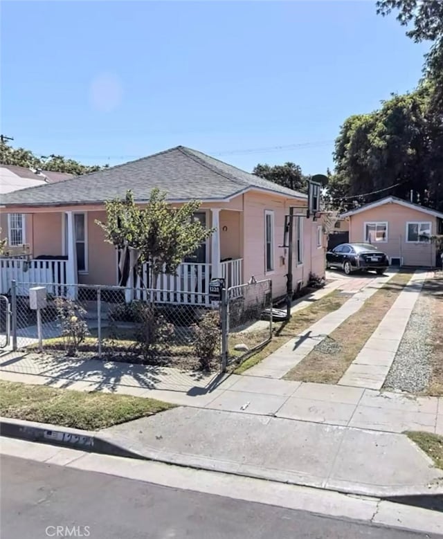 12201222 E 49th St, Los Angeles, CA 90011 - view of front of home featuring a fenced front yard, a porch, concrete driveway, and roof with shingles