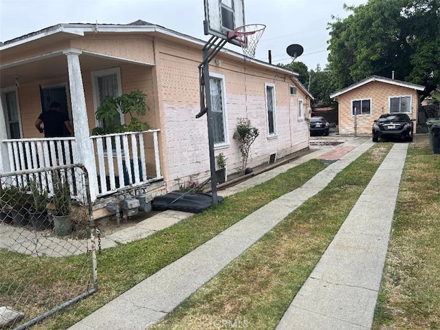 12201222 E 49th St, Los Angeles, CA 90011 - view of property exterior featuring a porch and a lawn