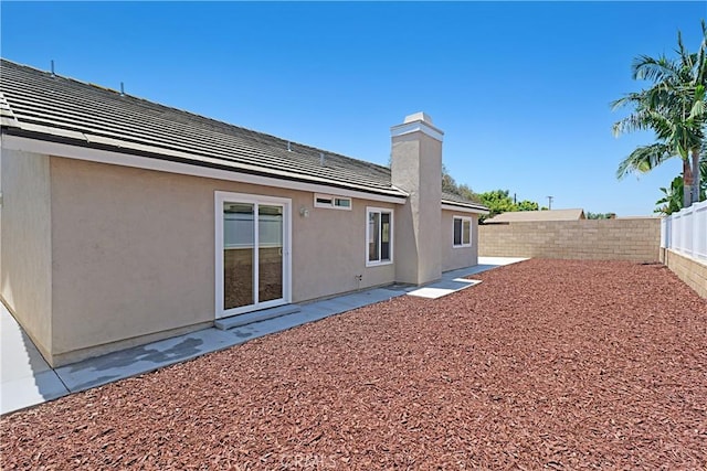 4004 Polk Ct, Chino, CA 91710 - back of property with a fenced backyard, stucco siding, and a chimney