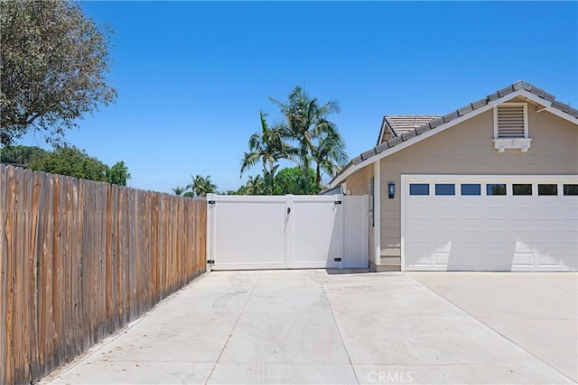 4004 Polk Ct, Chino, CA 91710 - view of property exterior with a gate, driveway, a tiled roof, and an attached garage