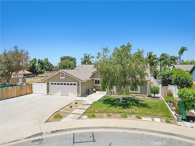 4004 Polk Ct, Chino, CA 91710 - obstructed view of property with concrete driveway, a garage, and a tile roof