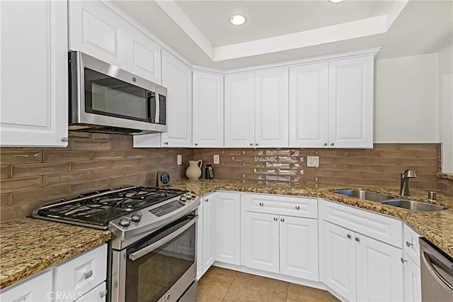 4004 Polk Ct, Chino, CA 91710 - kitchen with appliances with stainless steel finishes, a raised ceiling, white cabinetry, stone countertops, and recessed lighting
