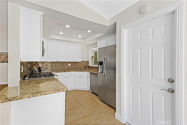 4004 Polk Ct, Chino, CA 91710 - kitchen featuring stainless steel appliances, tasteful backsplash, white cabinets, light stone counters, and recessed lighting