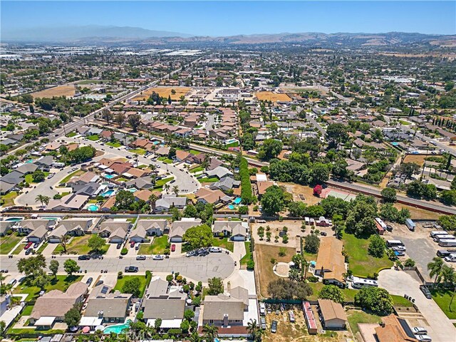 4004 Polk Ct, Chino, CA 91710 - aerial overview of property's location featuring a mountain backdrop and nearby suburban area