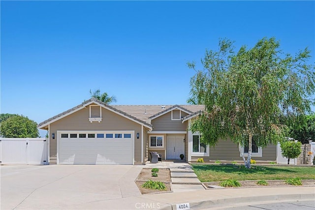 4004 Polk Ct, Chino, CA 91710 - view of front of house with driveway, an attached garage, a tile roof, and a gate