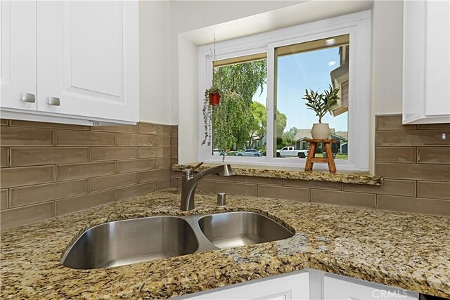4004 Polk Ct, Chino, CA 91710 - kitchen featuring white cabinets, tasteful backsplash, and light stone countertops
