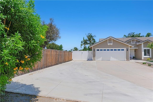 4004 Polk Ct, Chino, CA 91710 - view of side of home with a gate, concrete driveway, a garage, and a tile roof