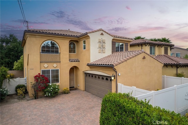 18141 Topham St, Tarzana, CA 91335 - mediterranean / spanish home featuring an attached garage, stucco siding, a tile roof, and decorative driveway