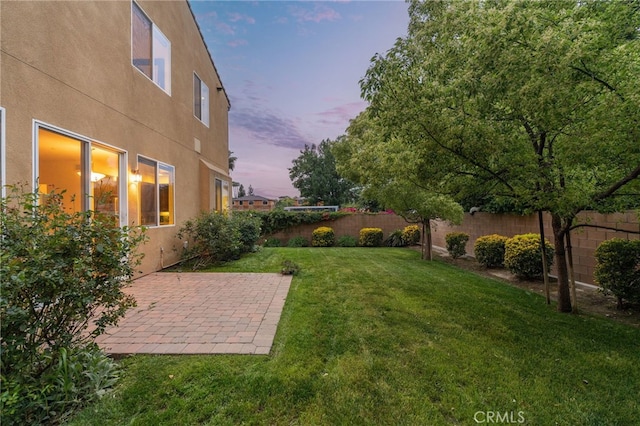 18141 Topham St, Tarzana, CA 91335 - yard at dusk featuring a fenced backyard and a patio area