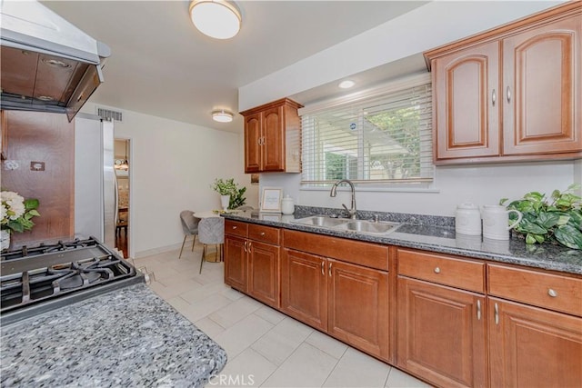 405 W Virginia Ave, Glendora, CA 91741 - kitchen with range hood, dark stone countertops, brown cabinets, and freestanding refrigerator