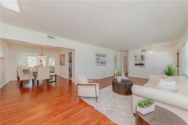 405 W Virginia Ave, Glendora, CA 91741 - living room featuring a chandelier and light wood-style flooring