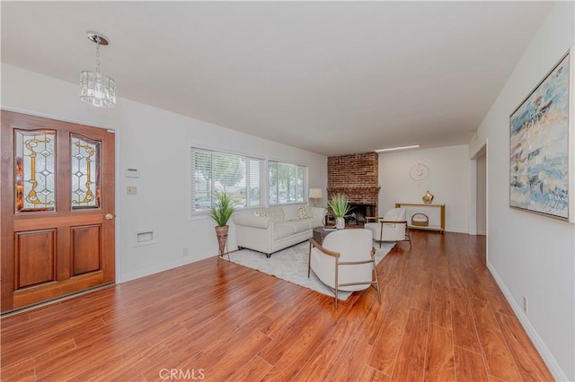 405 W Virginia Ave, Glendora, CA 91741 - living area featuring light wood finished floors, a fireplace, and a chandelier