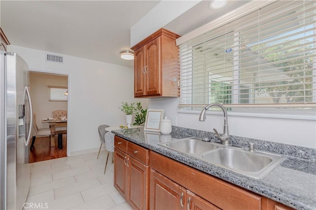 405 W Virginia Ave, Glendora, CA 91741 - kitchen featuring stainless steel fridge with ice dispenser, brown cabinets, healthy amount of natural light, and light tile patterned floors