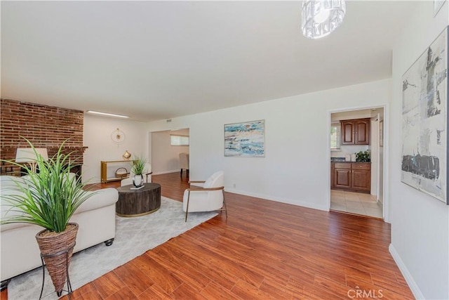 405 W Virginia Ave, Glendora, CA 91741 - living area featuring light wood finished floors and a brick fireplace