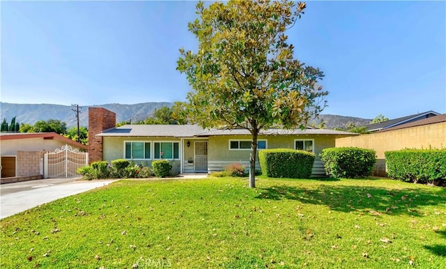 405 W Virginia Ave, Glendora, CA 91741 - single story home with a mountain view, a chimney, stucco siding, a gate, and concrete driveway