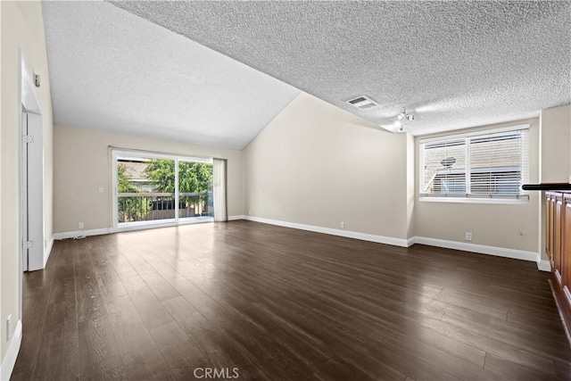6741 Caro St, Paramount, CA 90723 - unfurnished living room with a textured ceiling, dark wood-style flooring, and lofted ceiling