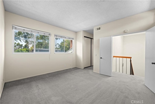 6741 Caro St, Paramount, CA 90723 - unfurnished bedroom featuring a textured ceiling and carpet floors