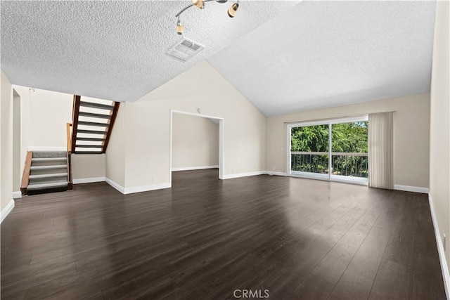6741 Caro St, Paramount, CA 90723 - unfurnished living room featuring a textured ceiling, dark wood-style floors, stairway, and lofted ceiling