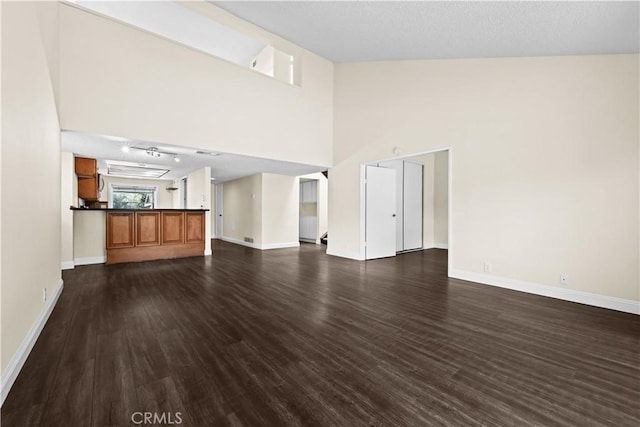 6741 Caro St, Paramount, CA 90723 - unfurnished living room with dark wood finished floors and high vaulted ceiling