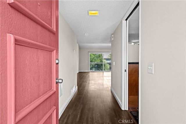 6741 Caro St, Paramount, CA 90723 - corridor with dark wood-type flooring and a textured ceiling