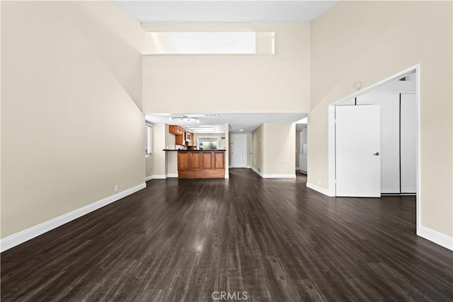 6741 Caro St, Paramount, CA 90723 - unfurnished living room featuring a high ceiling and dark wood-type flooring
