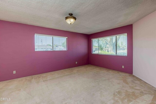 6000 Eugene Pl, Bakersfield, CA 93308 - unfurnished room with carpet flooring, healthy amount of natural light, and a textured ceiling