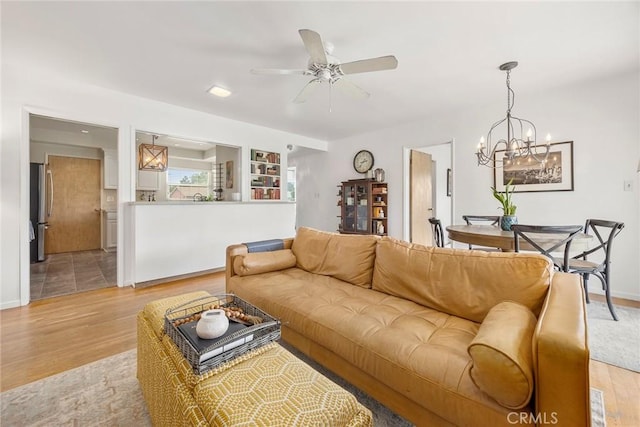 1642 W Woodcrest Ave, Fullerton, CA 92833 - living room with light wood finished floors, a ceiling fan, and a chandelier