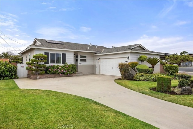 1642 W Woodcrest Ave, Fullerton, CA 92833 - ranch-style home featuring solar panels, a garage, concrete driveway, and roof with shingles