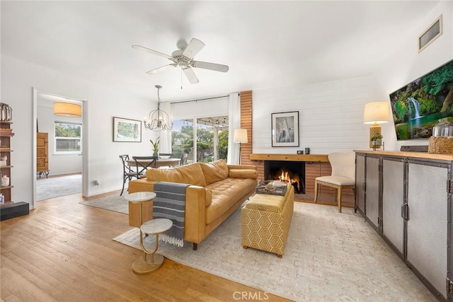 1642 W Woodcrest Ave, Fullerton, CA 92833 - living room featuring light wood finished floors, healthy amount of natural light, a ceiling fan, and a fireplace