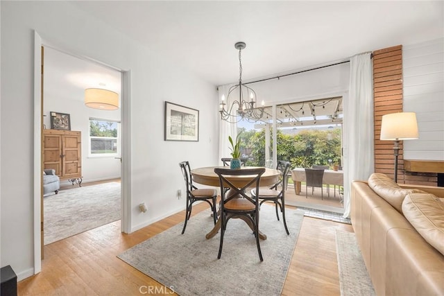 1642 W Woodcrest Ave, Fullerton, CA 92833 - dining space with light wood finished floors and a chandelier