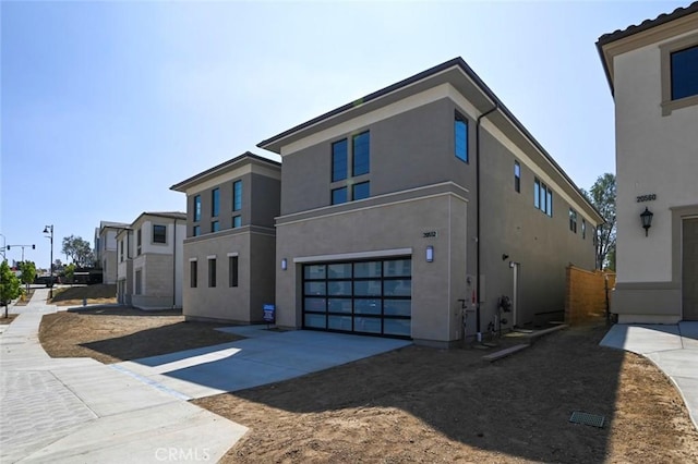 20552 Edgewood Ct, Chatsworth, CA 91311 - view of side of property with stucco siding, an attached garage, and concrete driveway