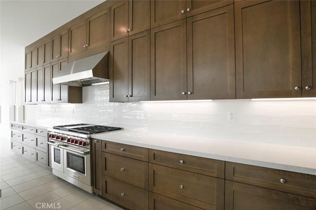 20552 Edgewood Ct, Chatsworth, CA 91311 - kitchen featuring range with two ovens, ventilation hood, tasteful backsplash, and light countertops