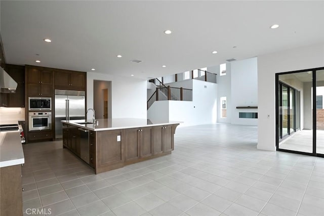 20552 Edgewood Ct, Chatsworth, CA 91311 - kitchen with built in appliances, light countertops, open floor plan, light tile patterned floors, and recessed lighting