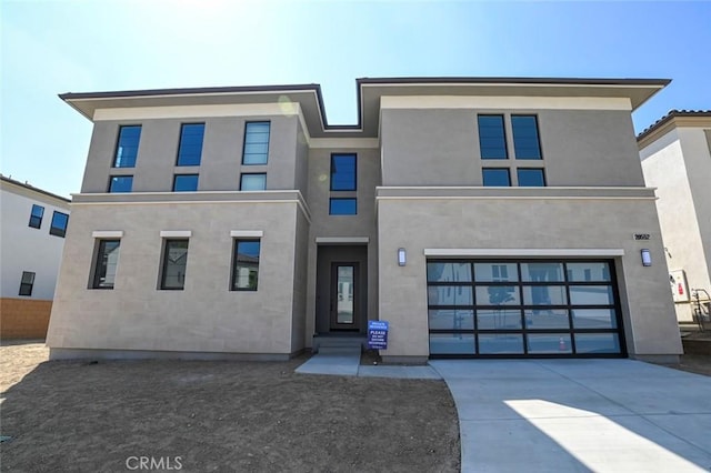 20552 Edgewood Ct, Chatsworth, CA 91311 - contemporary home featuring a garage, concrete driveway, and stucco siding