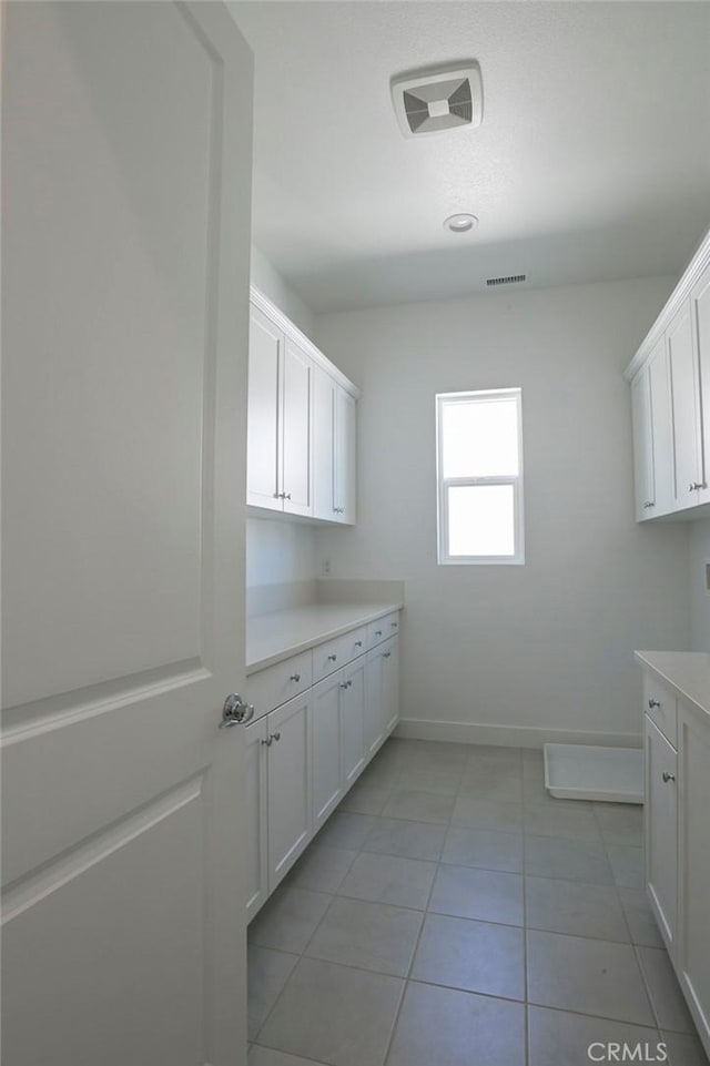20552 Edgewood Ct, Chatsworth, CA 91311 - laundry room with baseboards and light tile patterned flooring