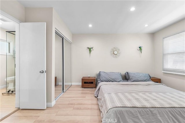 20322 Cantara St, Winnetka, CA 91306 - bedroom featuring light wood-style floors, recessed lighting, multiple windows, and a closet